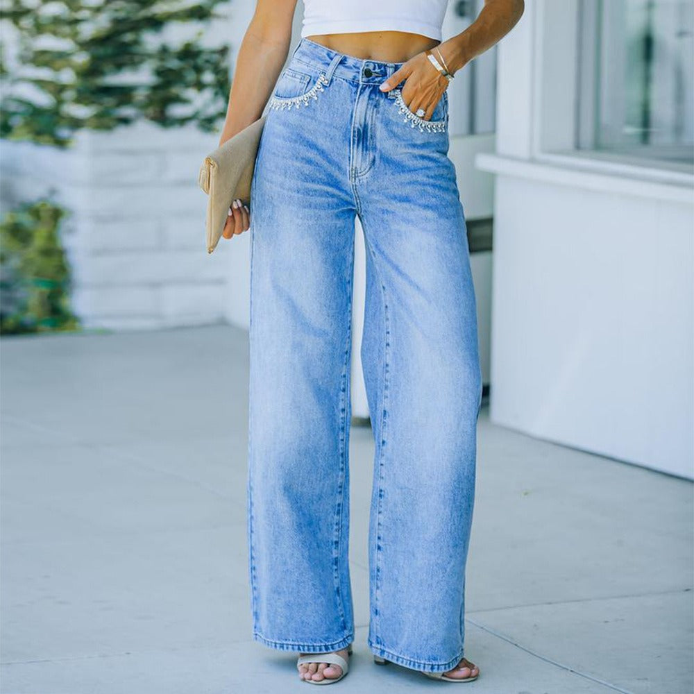 Model wearing "Ava" Petal Pocket Wide-Leg Denim Jeans in light blue with unique petal pocket detail, mid-waist fit outdoors.