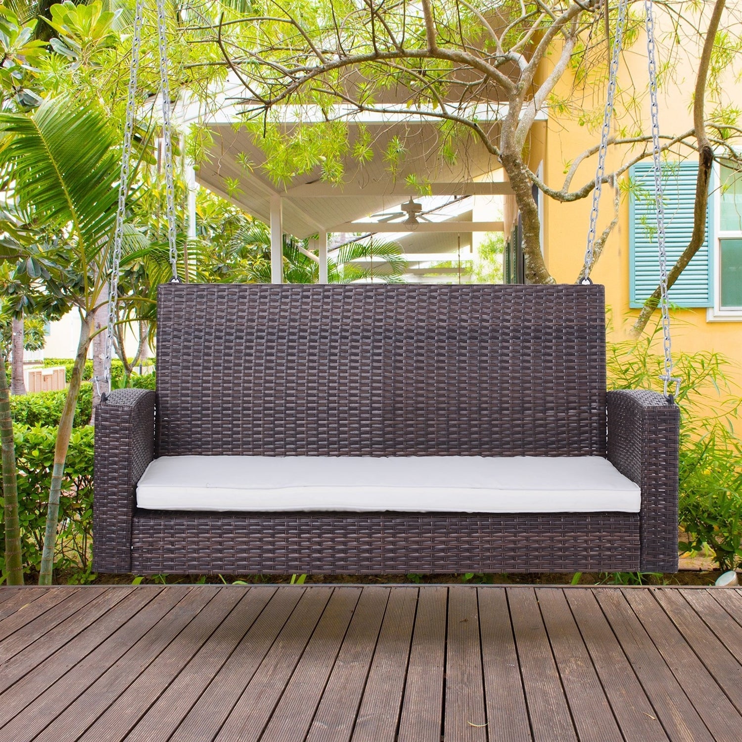 Espresso Wicker Porch Swing 7ft Hanging Chain with Cream Padded Cushion on porch.