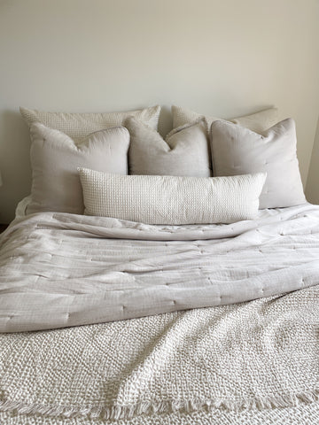 Easy Cotton Gauze Quilt & Pillow Set in beige and white, lightweight bedding for summer, made from 100% cotton, shown on bed.