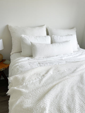 Easy Cotton Gauze Quilt & Pillow Set on a bed with beige and white colors for lightweight comfort.