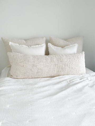 Easy Cotton Gauze Quilt & Pillow Set in beige and white on bed, showcasing soft and lightweight design for summer comfort.