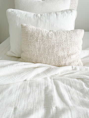 Easy Cotton Gauze Quilt & Pillow Set in beige and white displayed on a bed, emphasizing lightweight comfort for summer.