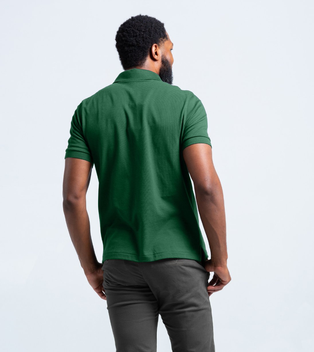Back view of a man wearing a green Short Sleeve Perfect Polo with StaySharp™ Collar