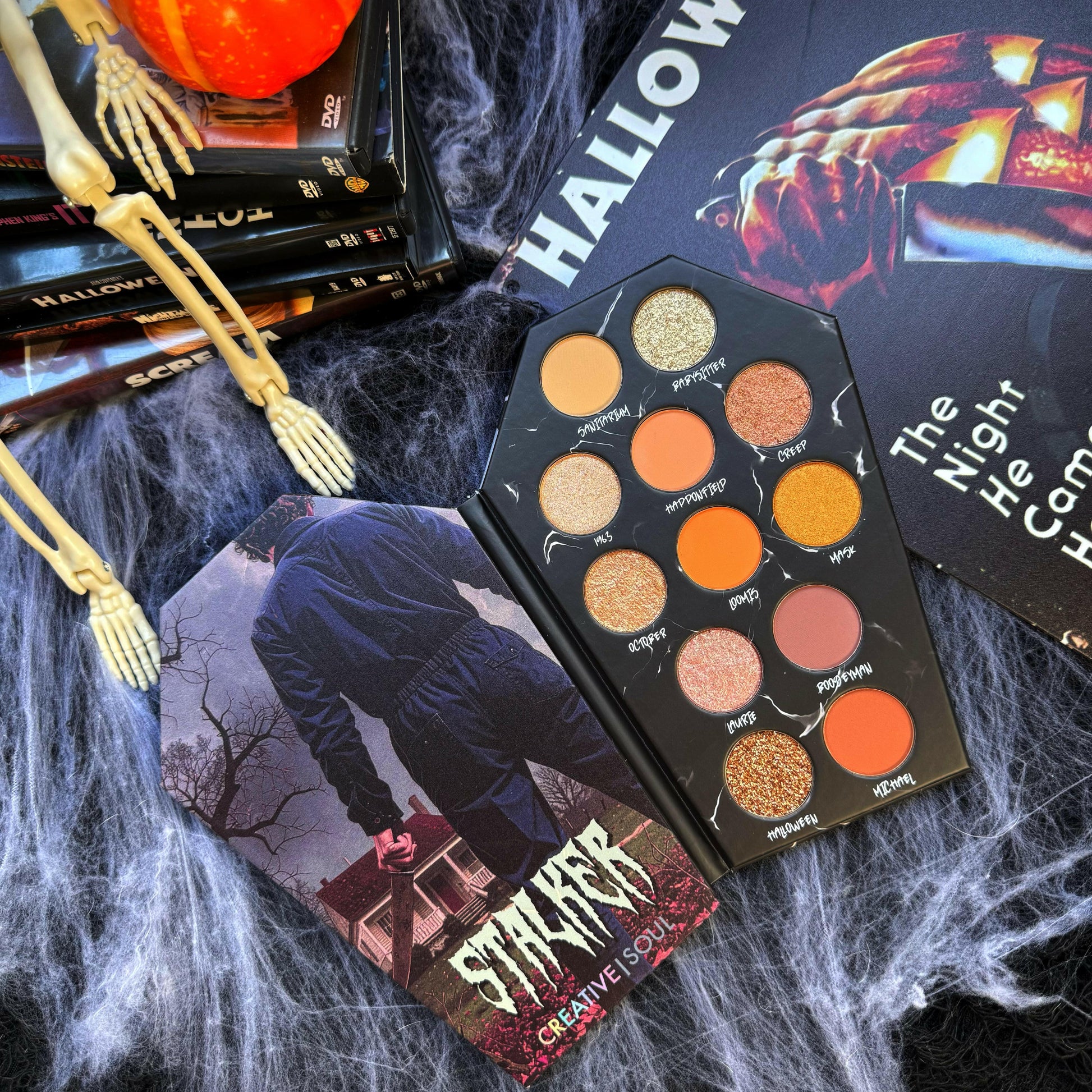 Stalker Eyeshadow Palette with various neutral shades and finishes on Halloween-inspired backdrop.