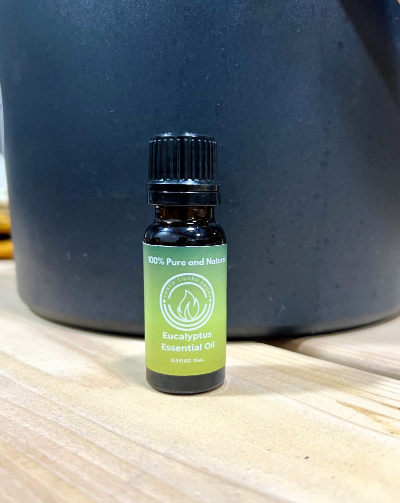 Eucalyptus Essential Oil bottle displayed on a wooden surface, promoting respiratory support and muscle relief benefits.