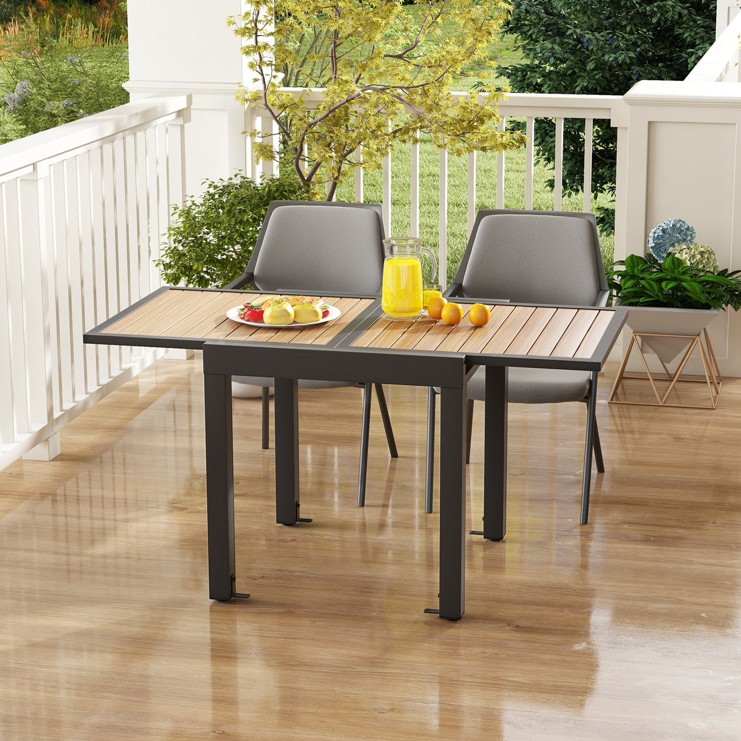 31.5-63 Inches Extendable Patio Table for 4-6 People-Natural with modern slatted top and rustproof aluminum frame on a patio.