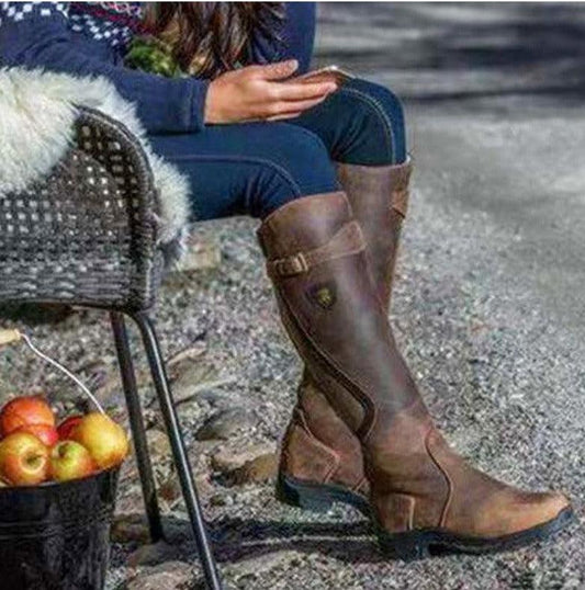 Person wearing Vintage Ride Leather Boots - Stylish Retro Riding Boots for Trendy Women sitting outdoors.