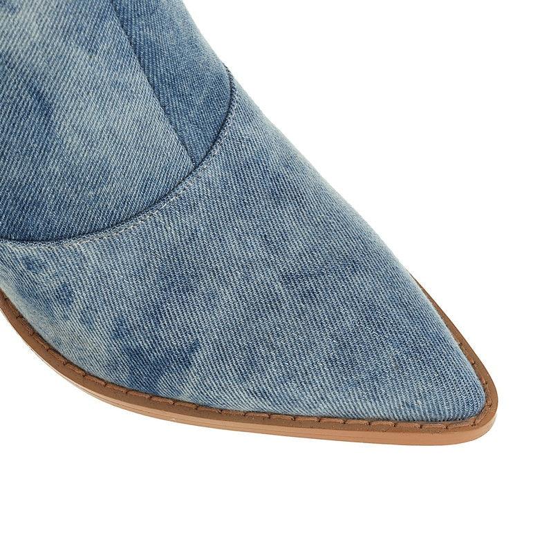 Close-up of the Tie Dye Denim Knee-High Cowgirl Boots showing the denim texture and pointed toe design.