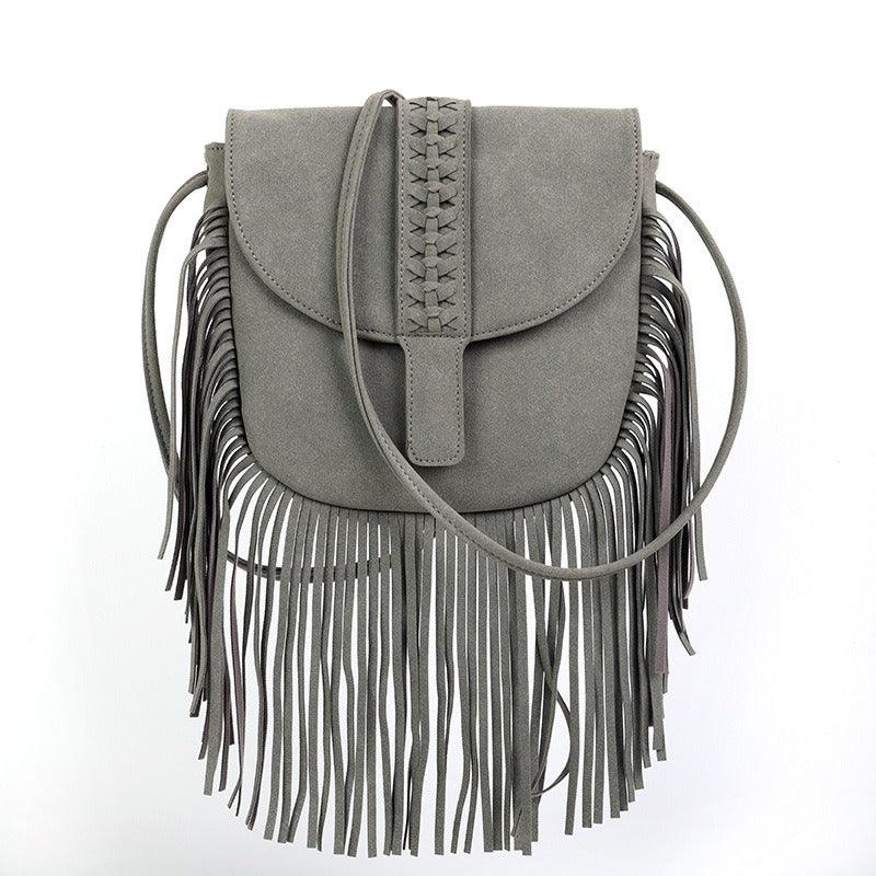 Dakota Tasseled Boho Leather Bag - Trendy Large Tassel Shoulder Bag with fringe detail and zipper closure.