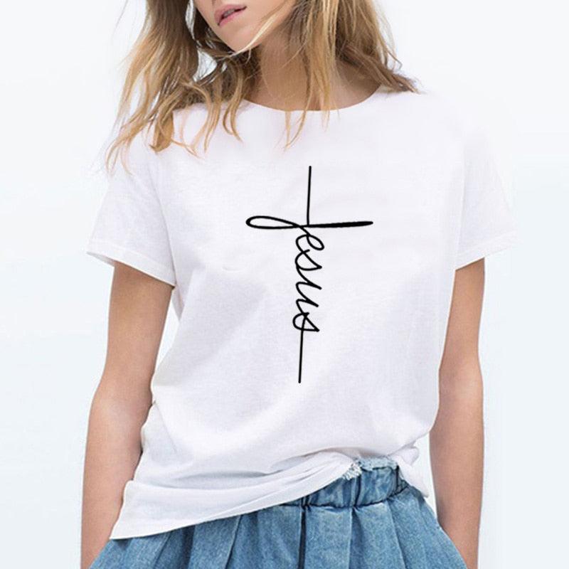 Woman wearing The Cross T-Shirt | Country Girl Faith Shirt for Spring & Summer with bold cross and 'Jesus' text design.