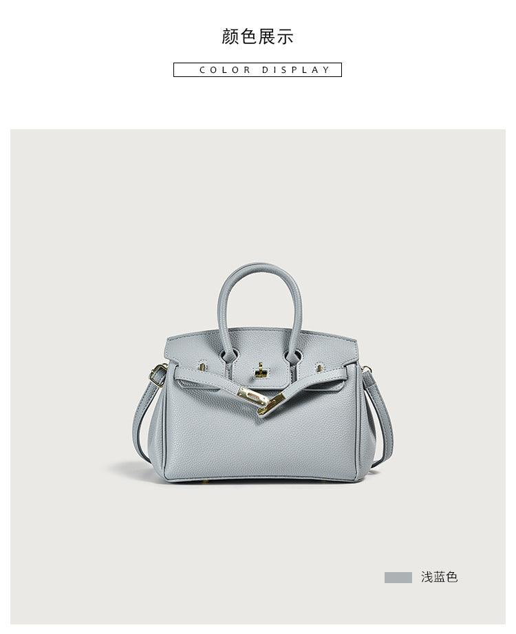 Light blue leather handbag with straps and classic closure on display