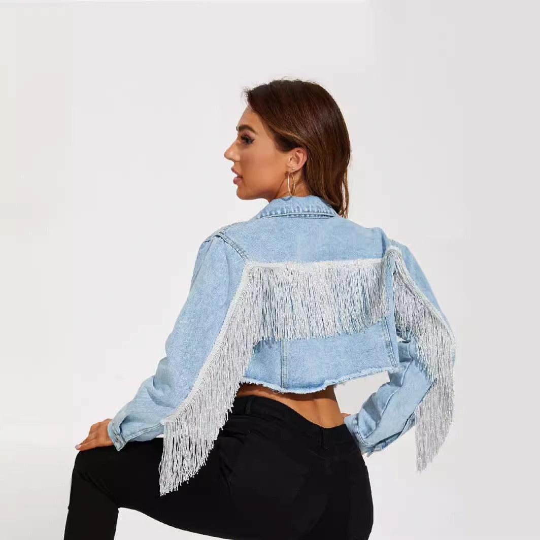 Model wearing Fringe Rider Short Denim Jacket with fringe detailing, showcasing vintage cool and contemporary flair in light blue cotton denim.