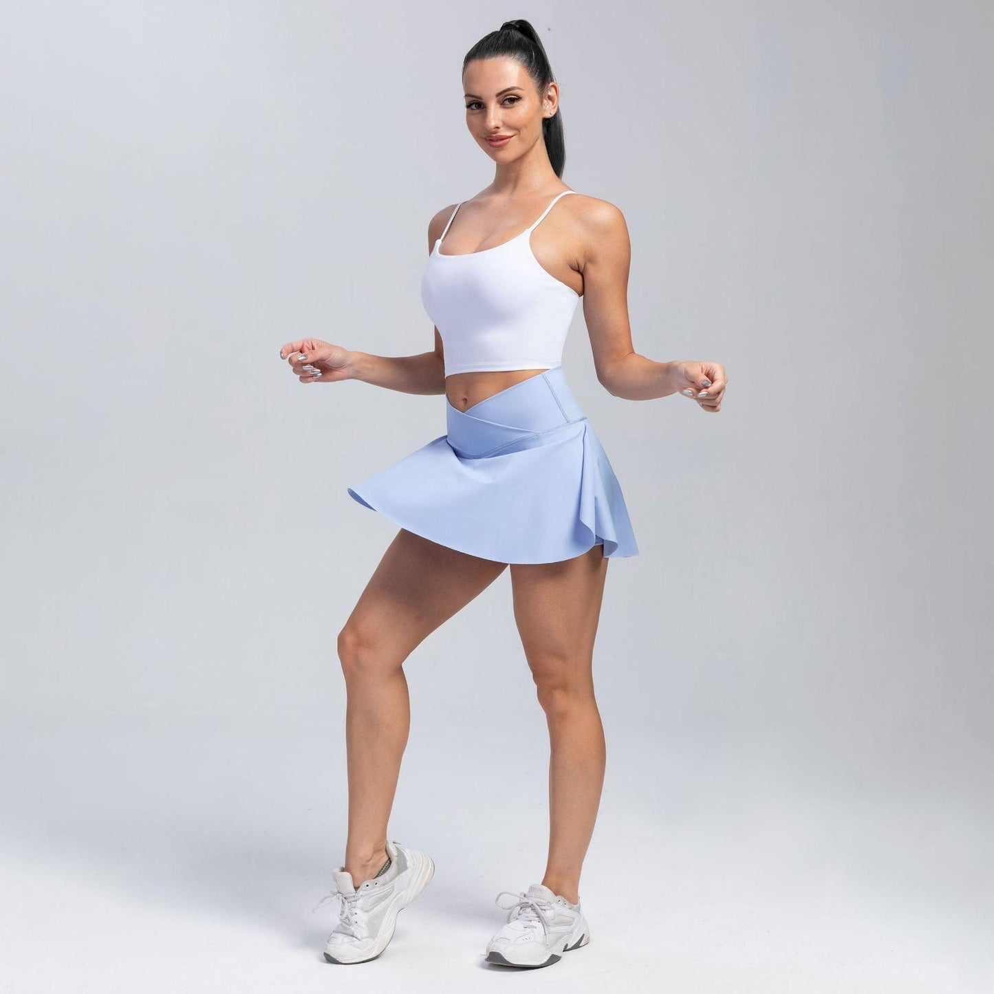 Woman wearing Cowgirl Fit High-Waisted Yoga Skirt Shorts, sporty and stylish activewear with a high waist and skirt overlay.
