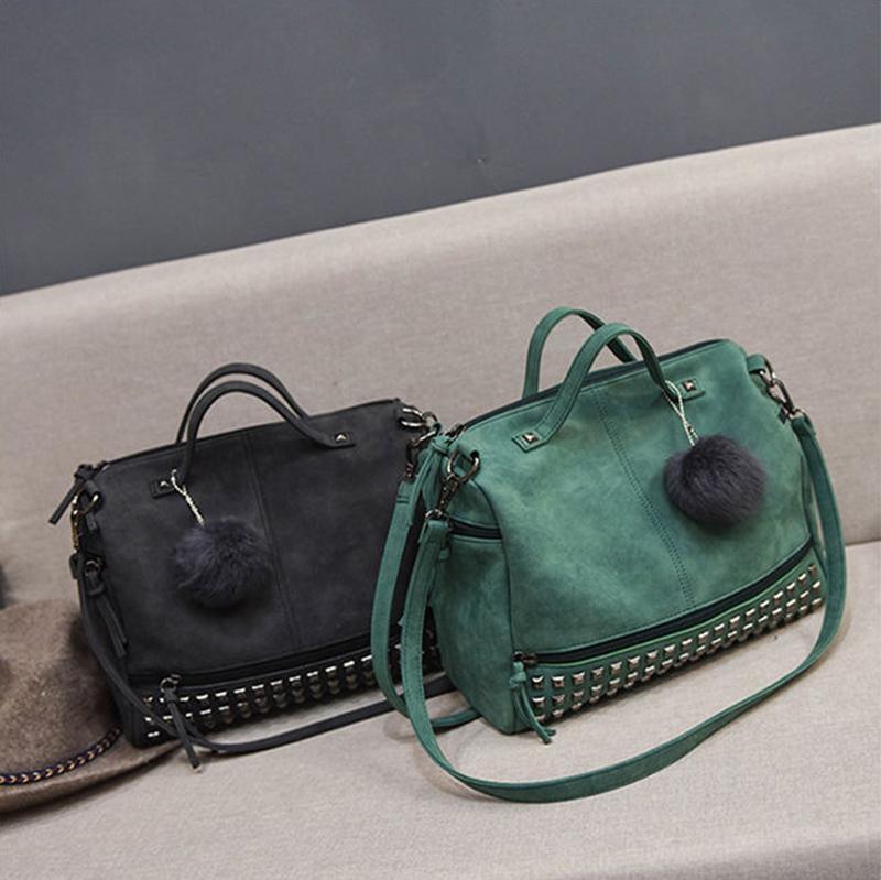Rustic Charm Leather Shoulder Bag – Stylish Cowgirl Handbag in black and green with rivet details, on a sofa.