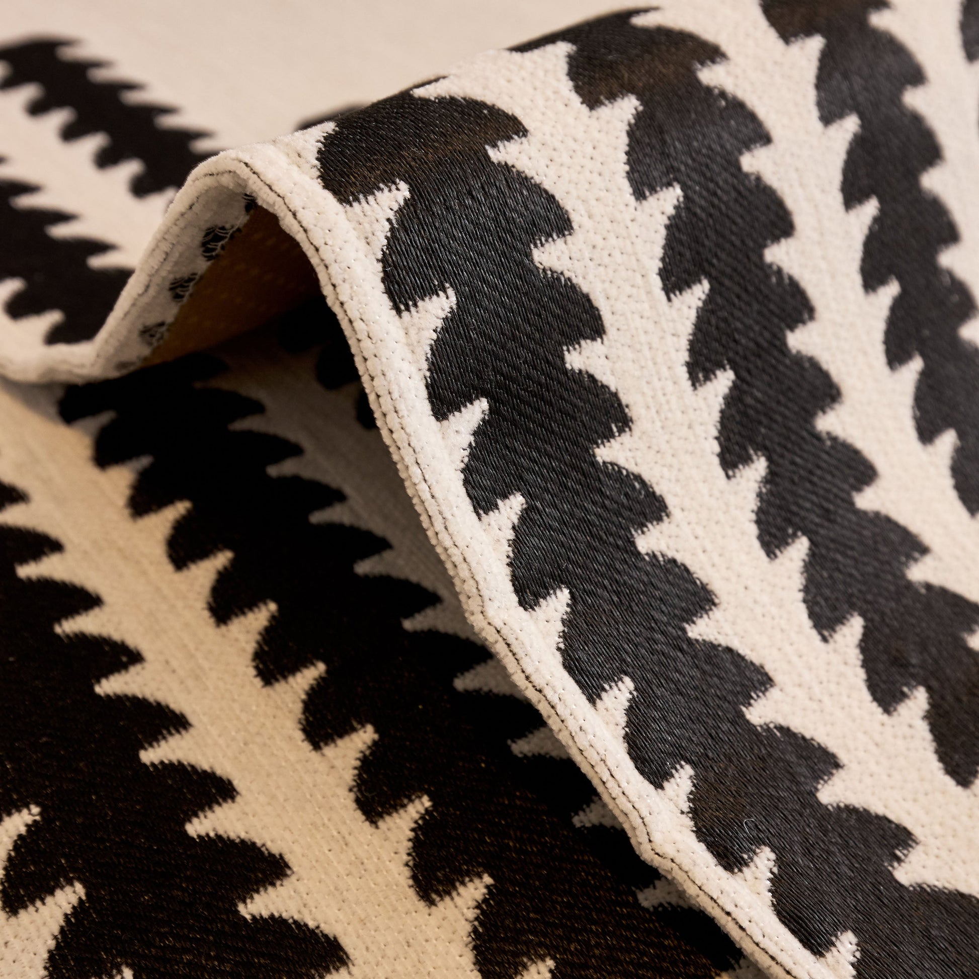 Close-up of chenille fabric with black and white zigzag pattern from Vertical Stripes Sectional Sofa Cover Slipcover - Non-Slip, Fits L-Shape Couches.