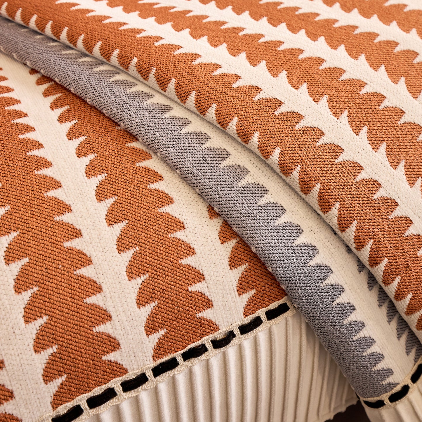 Close-up of Vertical Stripes Sectional Sofa Cover Slipcover featuring modern geometric pattern in chenille fabric with non-slip backing.