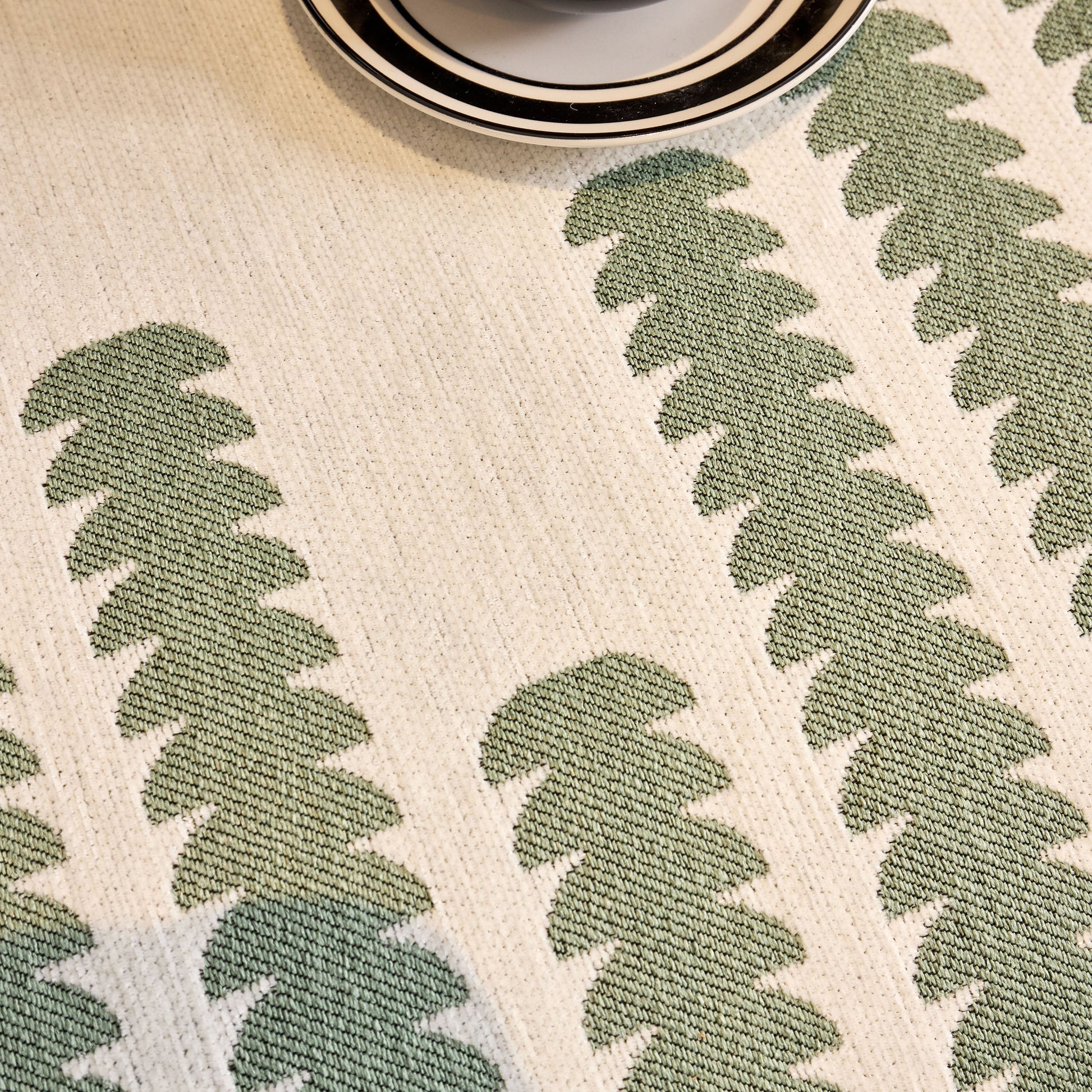 Close-up of fabric with modern geometric green pattern in zigzag design
