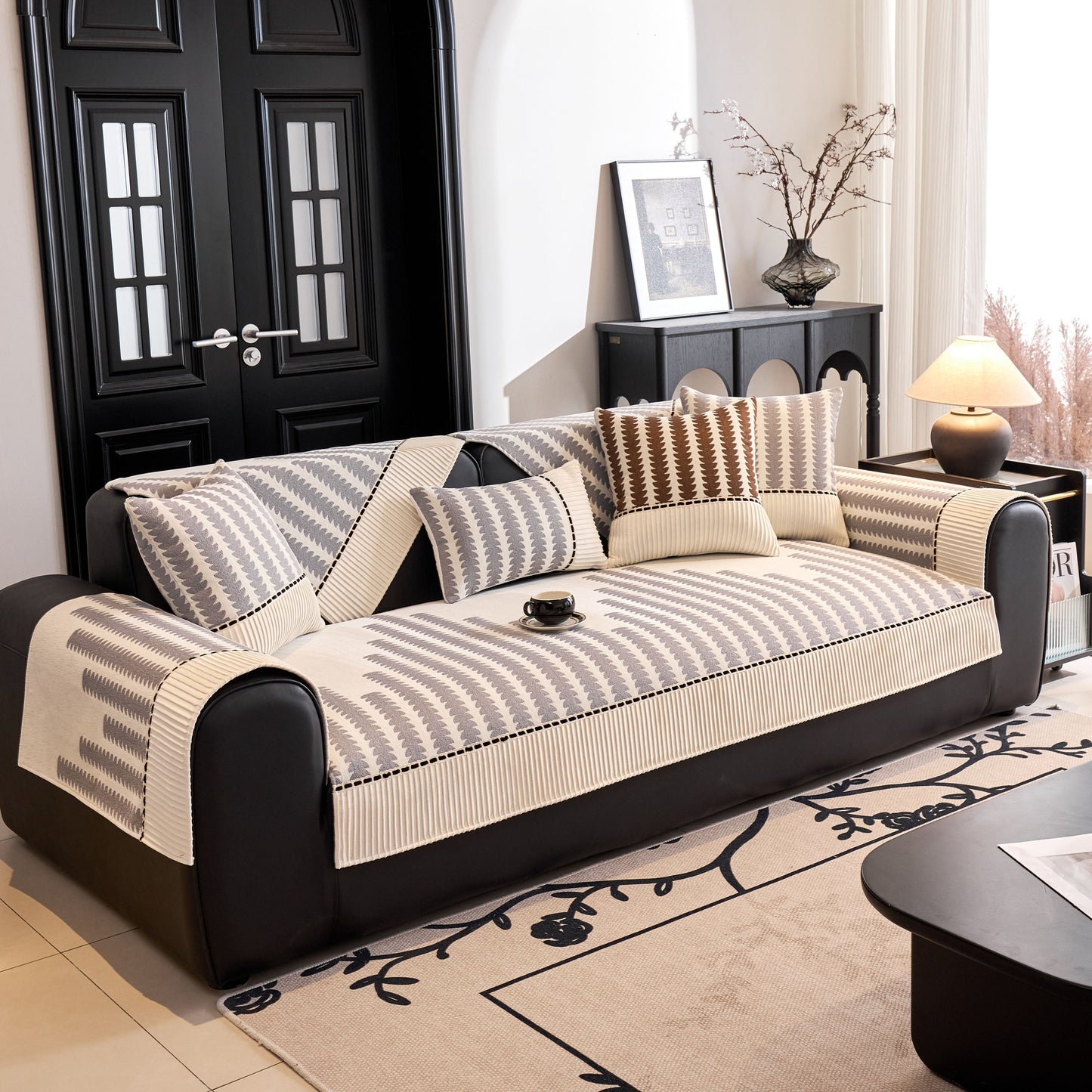 Vertical Stripes Sectional Sofa Cover Slipcover - Non-Slip, Fits L-Shape Couches on a black leather sofa in a modern living room