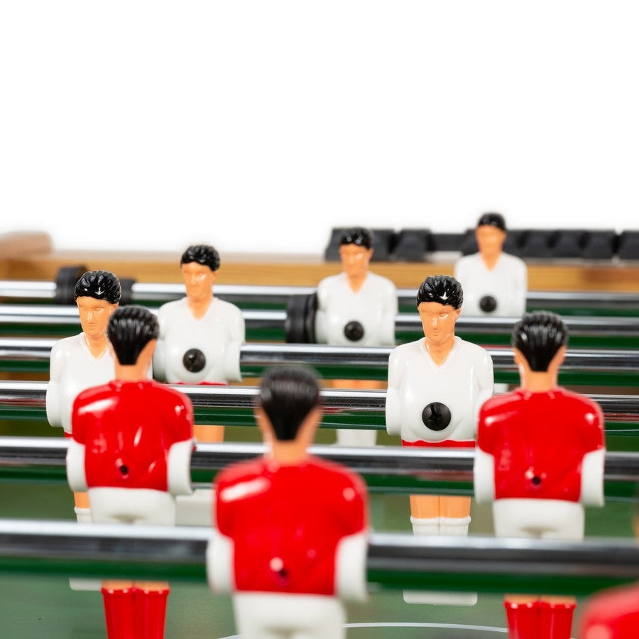 Close-up of players on Competition Arcade Waist Height Foosball Table with red and white team figures on steel rods.