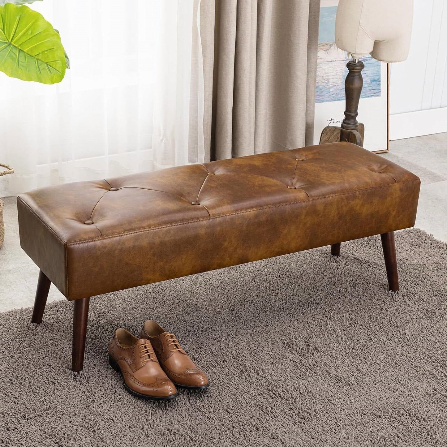 Mid-Century End of Bed Bench with Brown Leather Upholstered Seat Solid Wood Legs in bedroom setting with shoes on rug