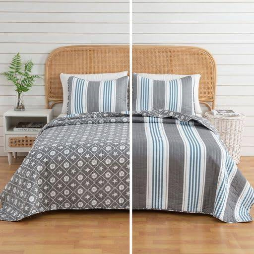 Full/Queen 3 Piece Coastal Starfish Sand Dollar Grey Blue White Quilt Set on bed with reversible design.