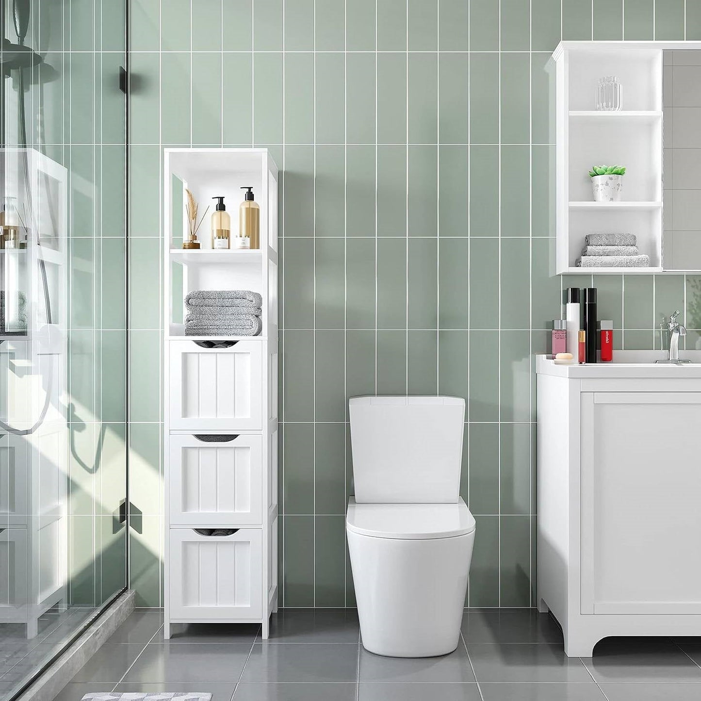 Bathroom Cabinet Tower with 3 Storage Drawers and 2 Shelves in White Wood Finish next to modern vanity and toilet in tiled bathroom