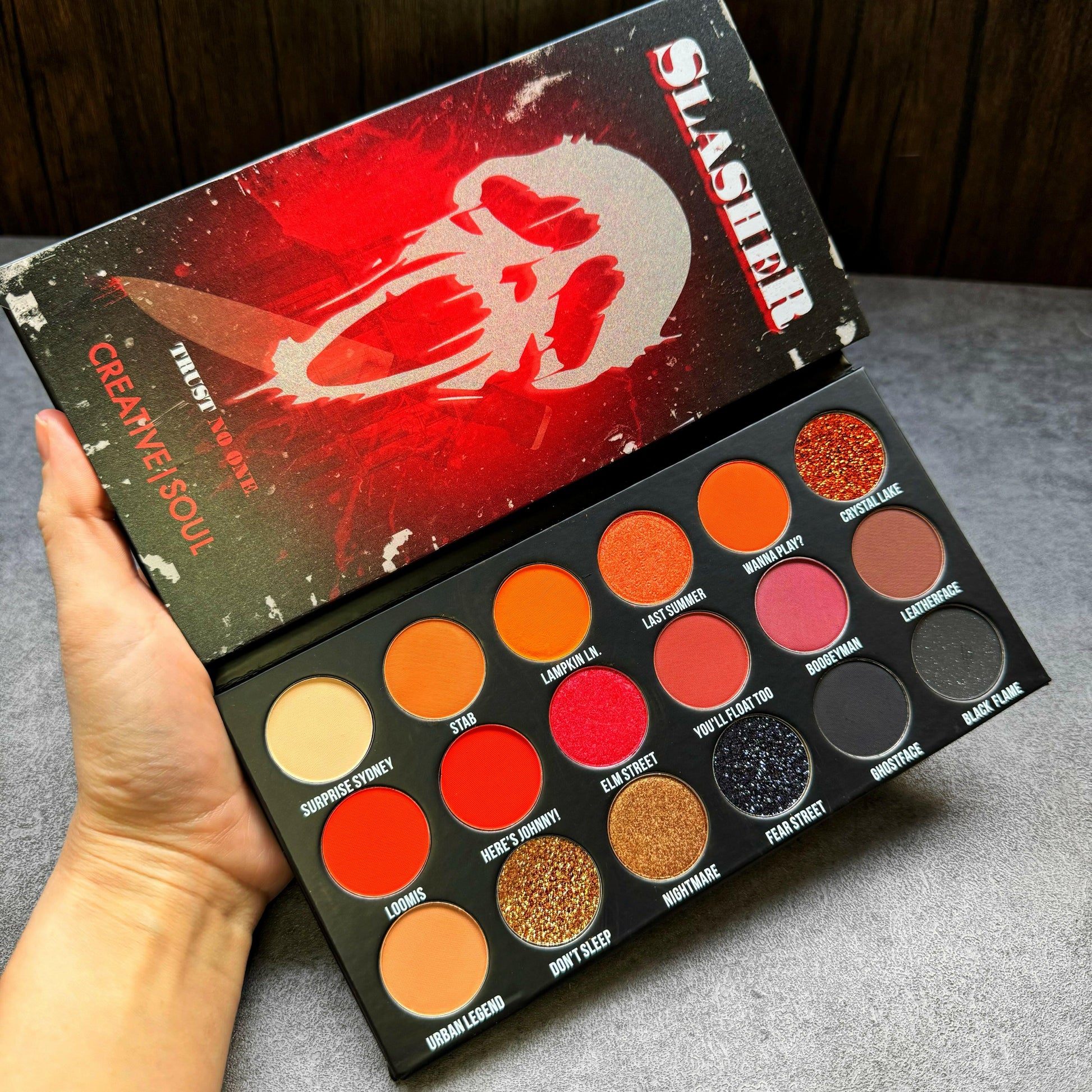 Slasher Eyeshadow Palette with vibrant shades inspired by 90's VHS horror movies, featuring intense and bold colors in an open display.