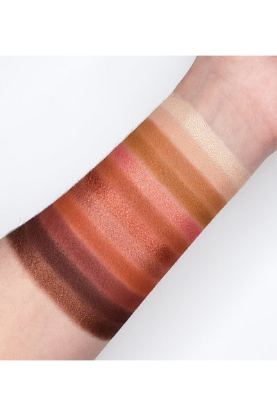 Swatches of warm-toned eye palette Go2 FOGO - GES05 showcasing full-pigmented matte, metallic, and micro shimmer shades on arm.