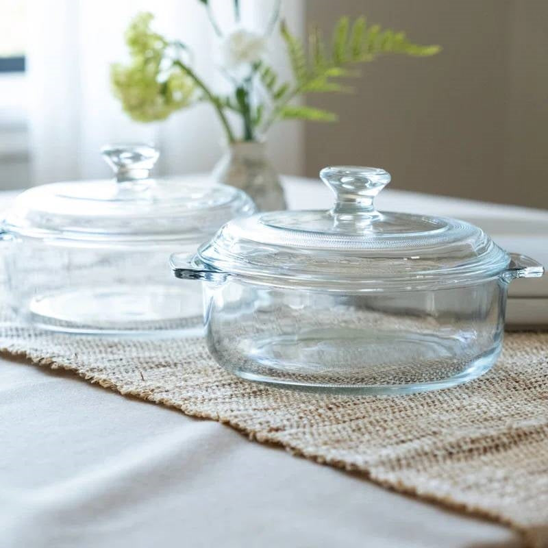 Set of 2 - 1-Quart Glass Dutch Oven Casserole Bakeware Baking Dishes with Lids displayed on a table with natural light.