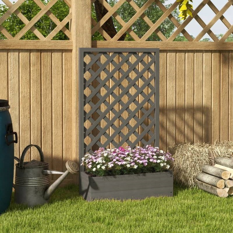 Outdoor Raised Garden Bed Planter Box with Lattice Trellis in Grey Wood Finish placed in garden setting with flowers and watering can.