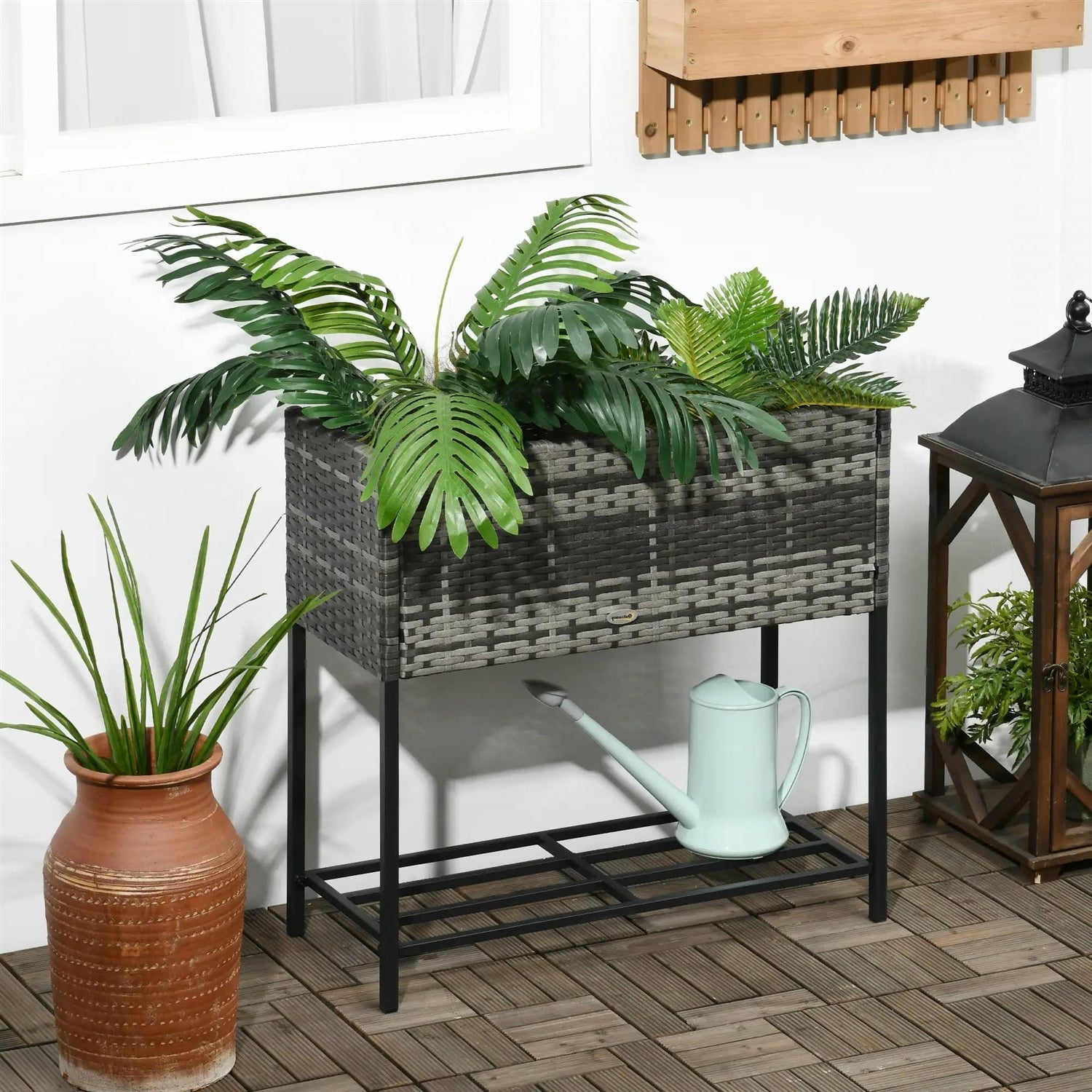 Grey Modern PE Rattan Wicker Raised Garden Bed Elevated Planter Box with plants on a patio.