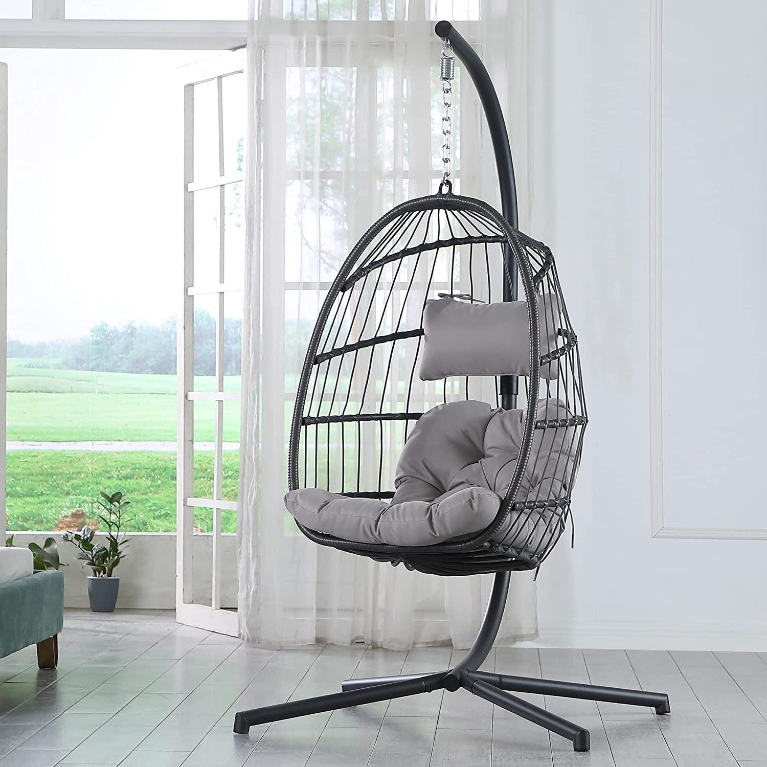 Modern Grey Indoor/Outdoor Wicker Rattan Aluminum Frame Swing Egg Chair Hammock in a bright room setting.