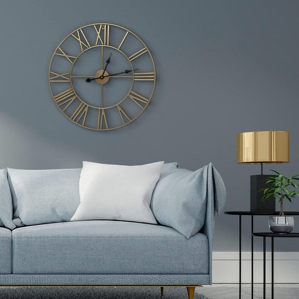 Round 24-inch Decorative Gold Metal Wall Clock Roman Numerals and Black Hands displayed in a stylish living room setting.