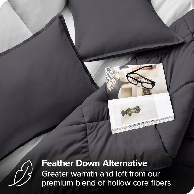 Twin/Twin XL Size All Season Super Soft Down Alternative Comforter Set Grey with pillows and magazine on dark comforter.