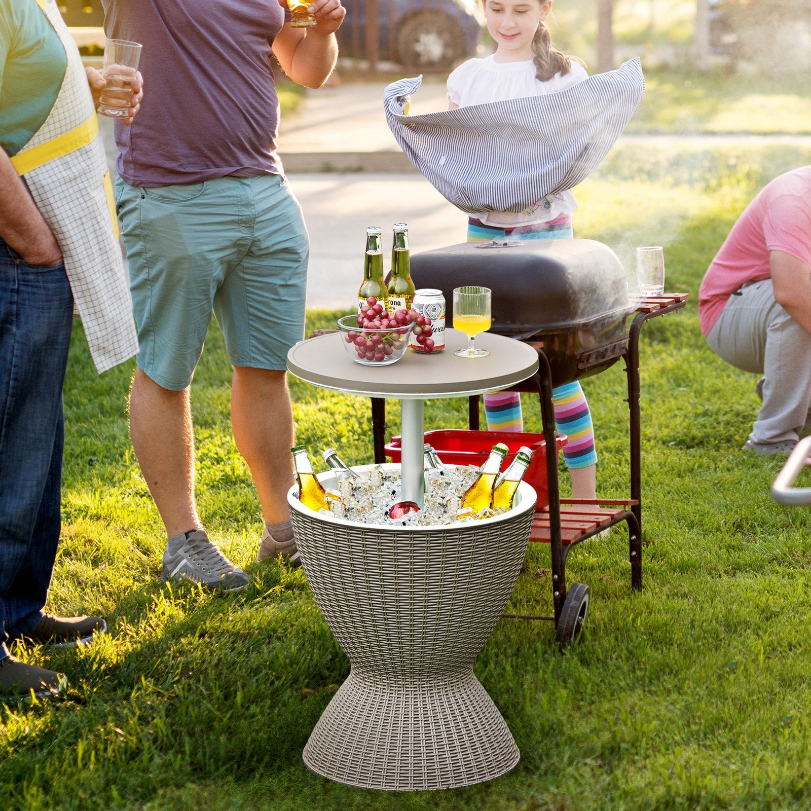 Group enjoying a barbecue with a 3 in 1 8 Gallon Patio Rattan Cooler Bar Table with Adjust Ice Bucket-Brown, filled with drinks and snacks.