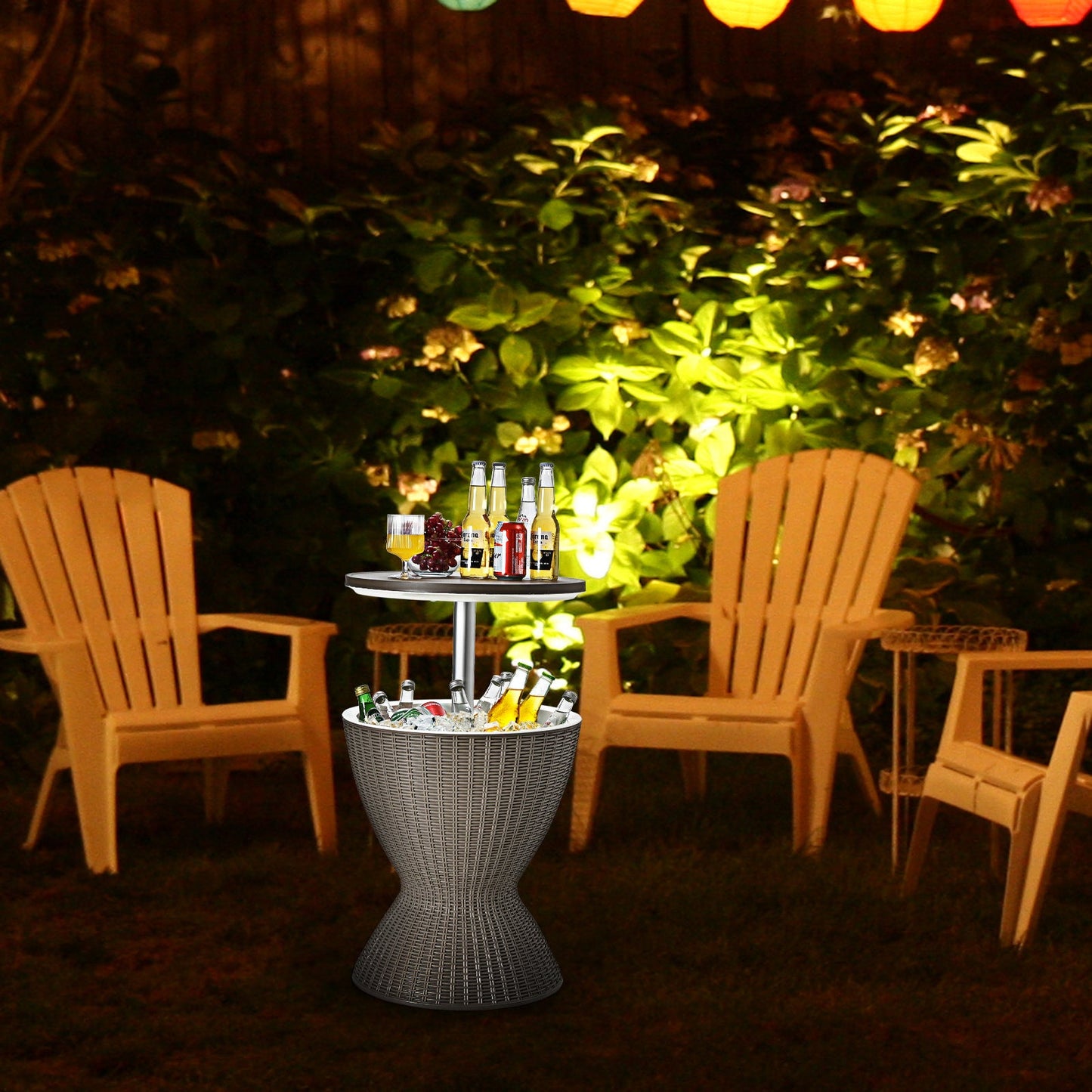 3 in 1 8 Gallon Patio Rattan Cooler Bar Table with Adjust Ice Bucket-Brown in a garden setting with chairs and lights, filled with drinks.