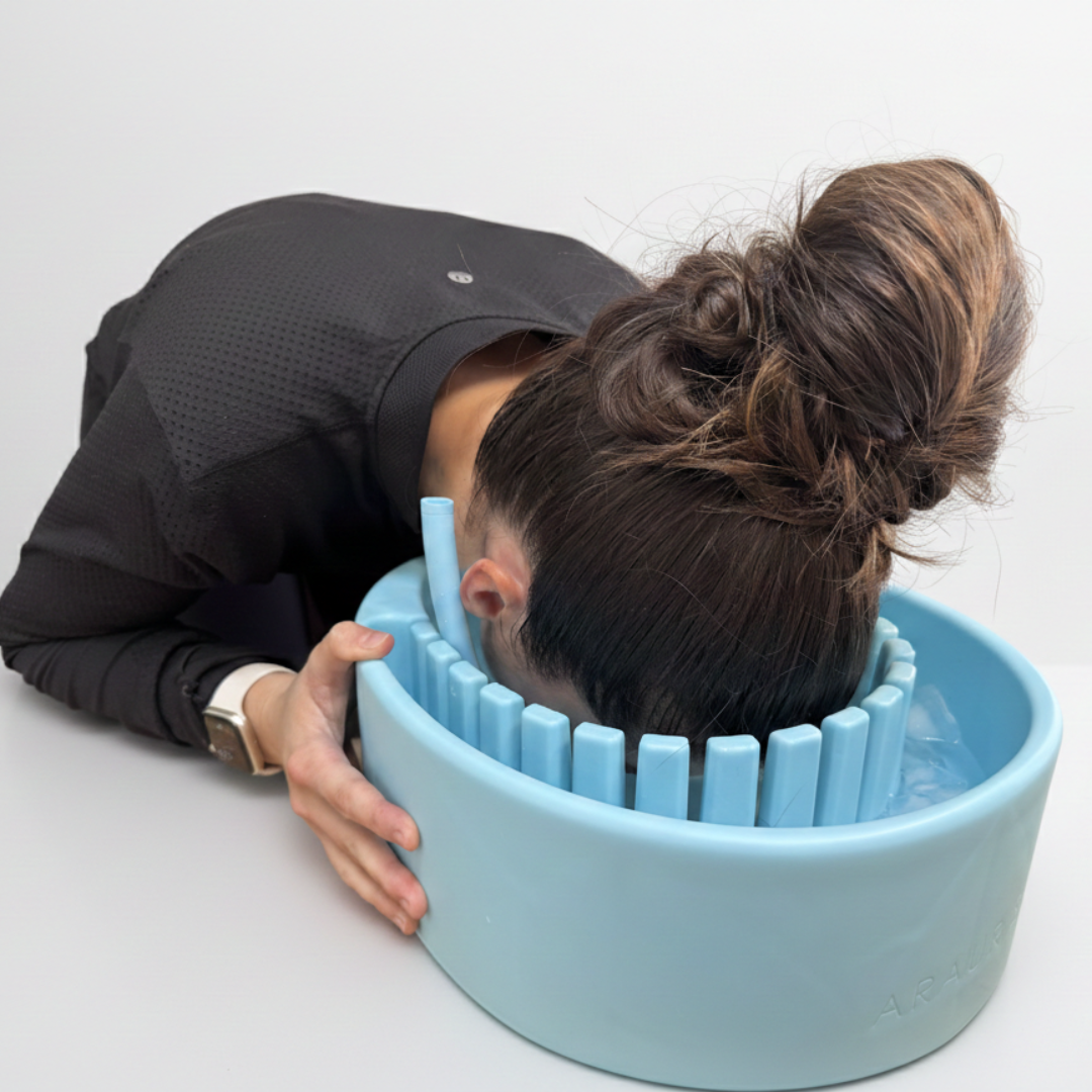 Woman using Arauris Pure - Facial Cold Plunge Bowl with Ice Chamber for skincare therapy