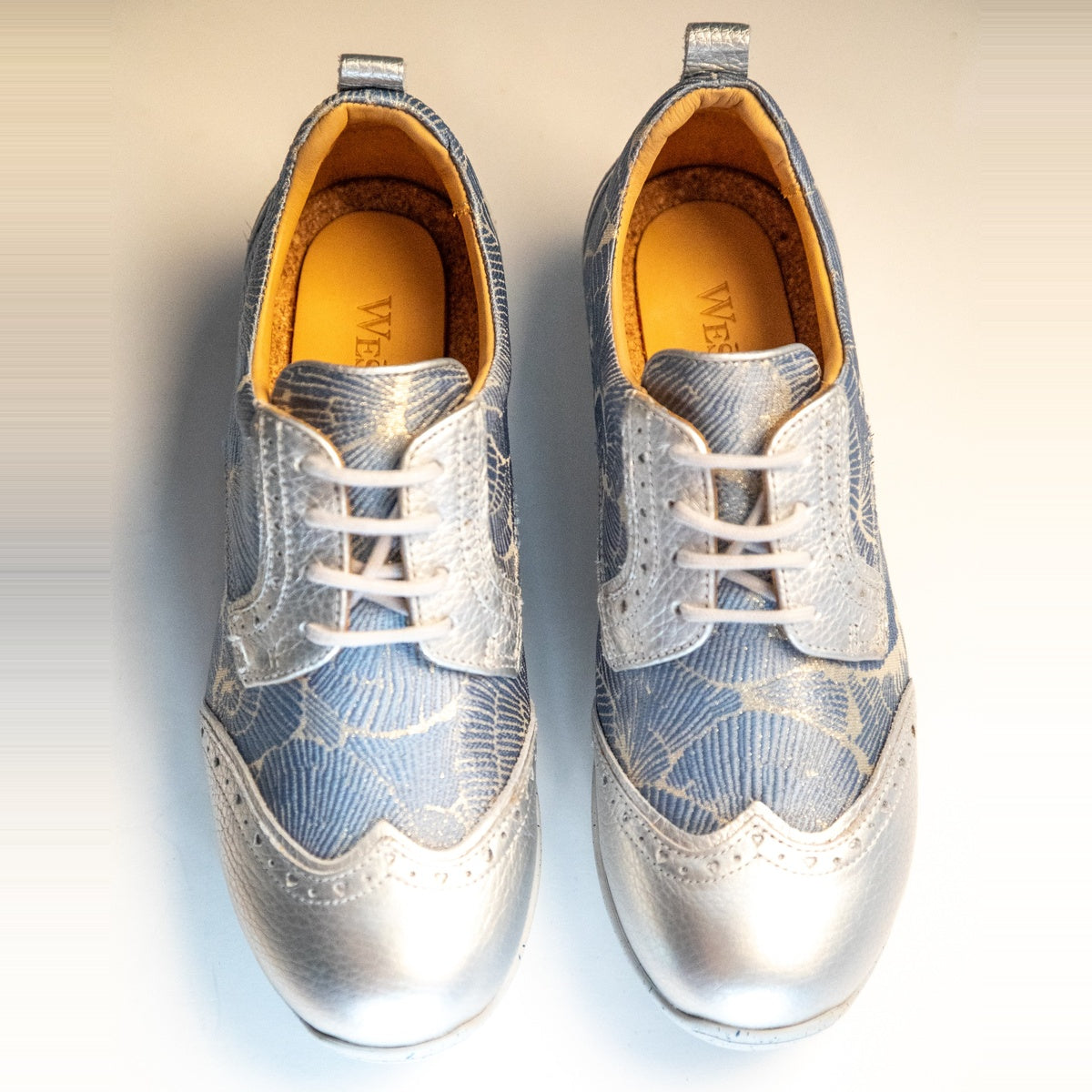 WesTees Grace shoes featuring abstract blue and silver print lace, breathable cork insole, and foam cushioning for golf elegance.