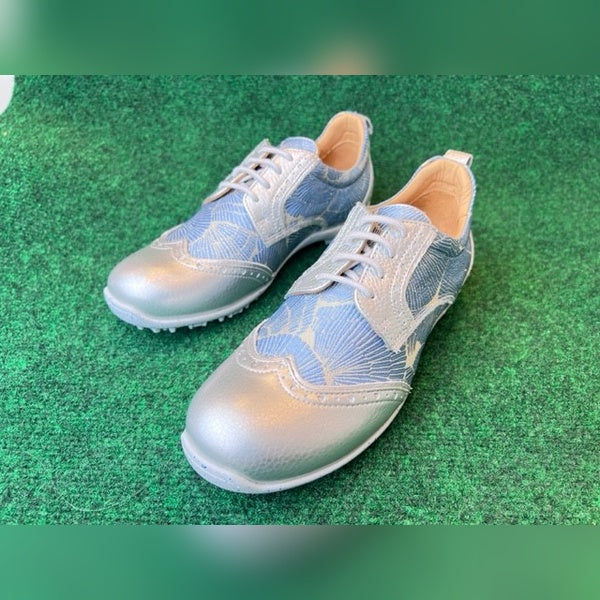 WesTees Grace shoes with abstract blue and silver design, featuring removable cork insole and foam ankle cushioning on green surface.