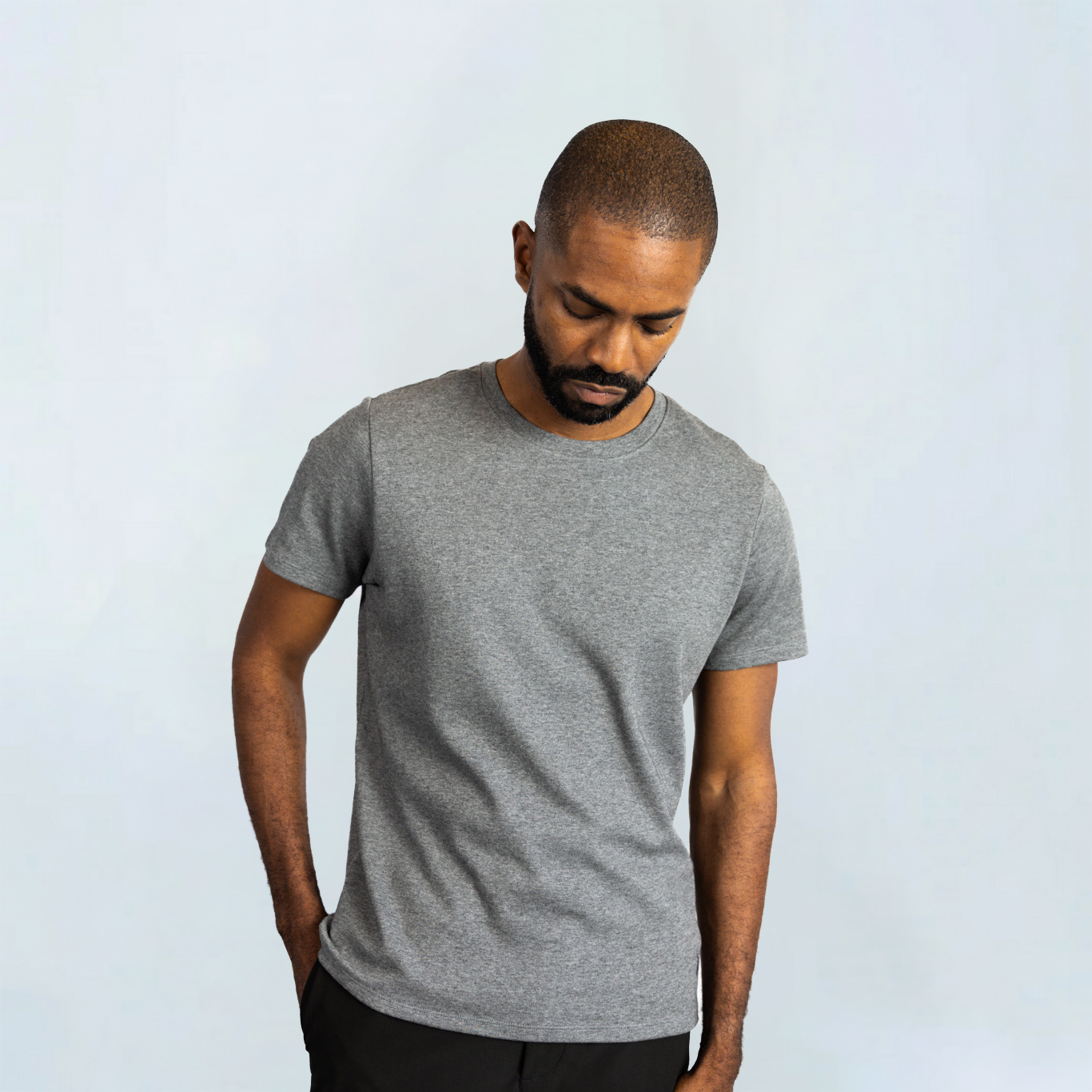Man wearing a gray Short Sleeve Perfect Tee, made from Peruvian Pima cotton, showcasing its wrinkle resistance and moisture-wicking features.