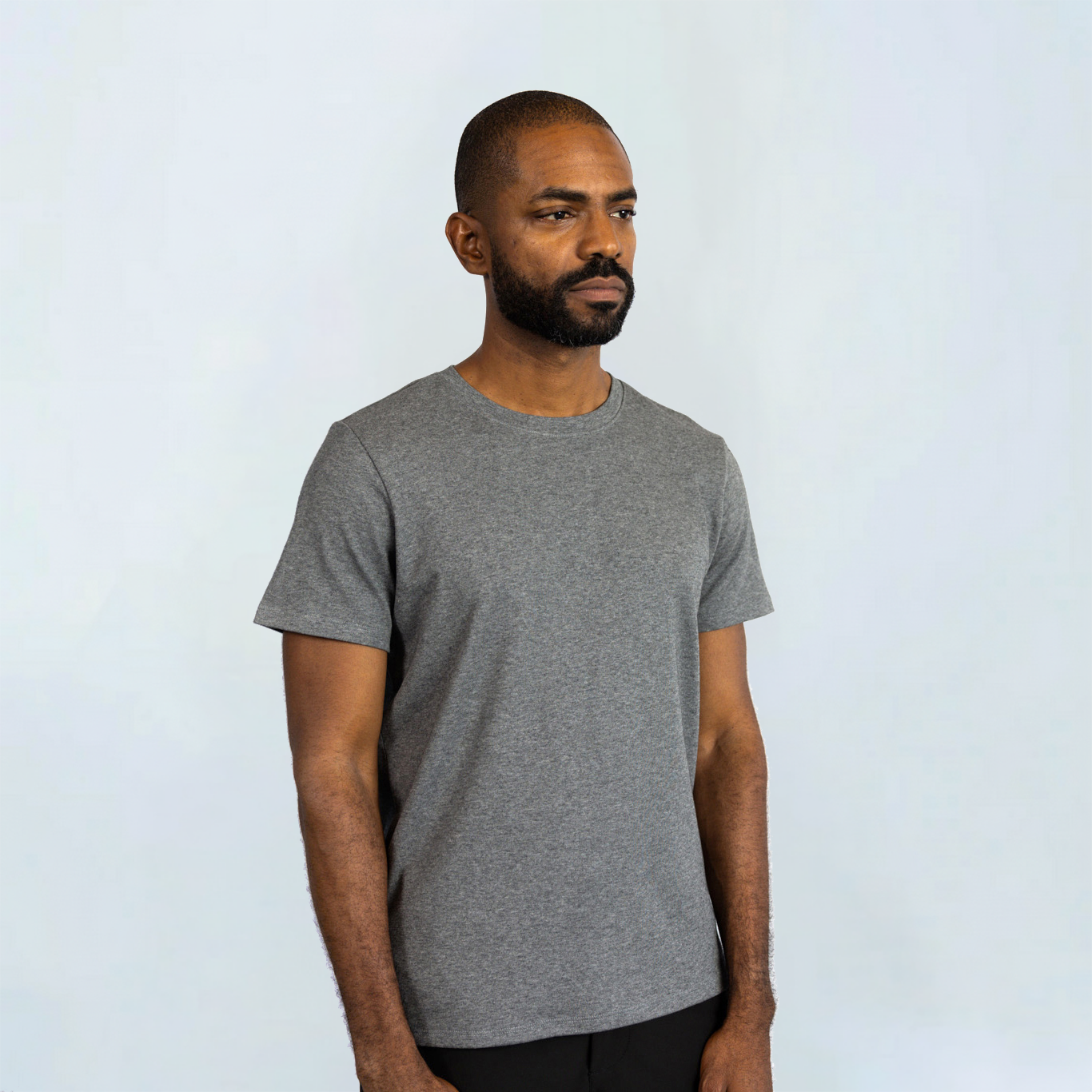 Man wearing a grey Short Sleeve Perfect Tee made from Peruvian Pima cotton, showcasing its softness and wrinkle-resistant features.