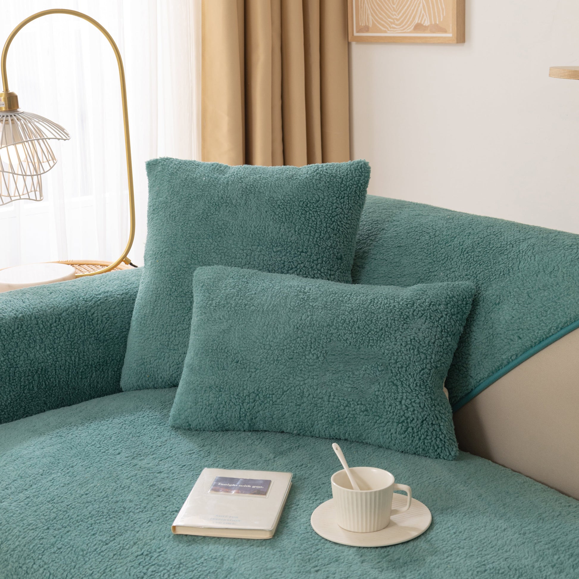 Luxury Sherpa Fleece Solid Sofa Towels Thickened Plush Non Slip Sofa Cushion Covers in teal on a cozy living room sofa with books and a cup