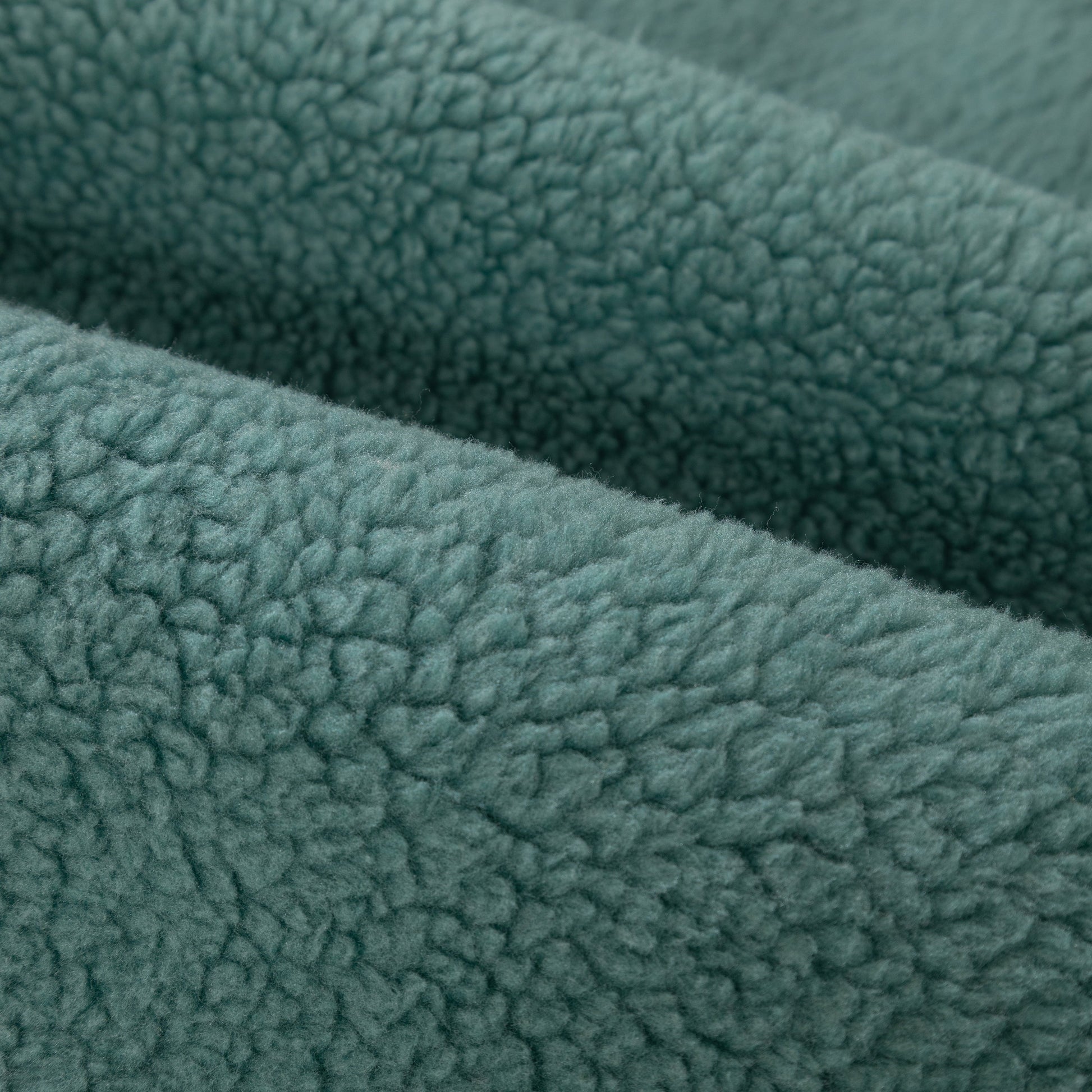 Close-up of green Luxury Sherpa Fleece Solid Sofa Towels Thickened Plush Non Slip Sofa Cushion Covers texture.