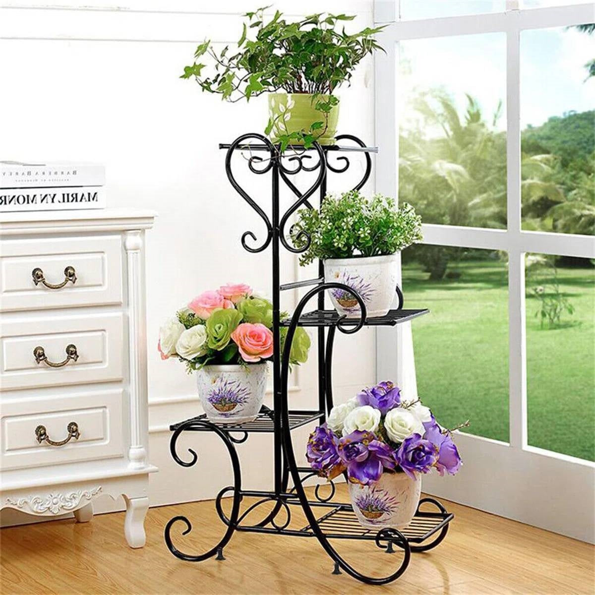 Elegant Black Metal 4-Shelf Plant Stand displaying colorful potted flowers indoors near a window.