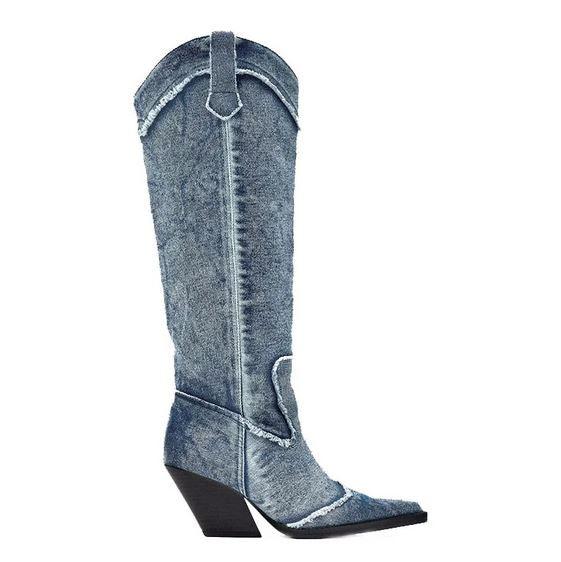 Handcrafted Distressed Denim Knee-High Boots with tall silhouette and canted high heels for a modern cowgirl style.