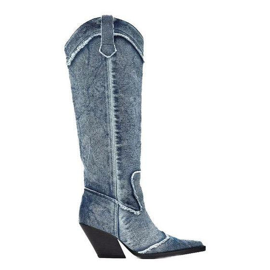 Handcrafted Distressed Denim Knee-High Boots with tall silhouette and canted high heels for a modern cowgirl style.