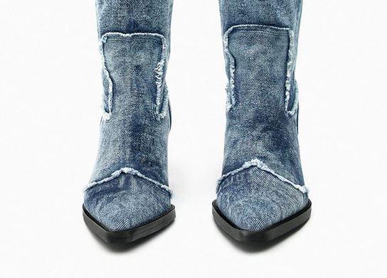 Close-up of Handcrafted Distressed Denim Knee-High Boots showcasing the rugged denim texture and expert craftsmanship.