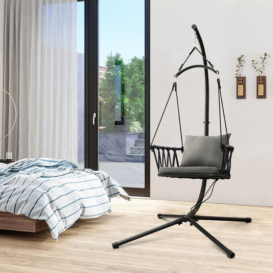 Hanging Swing Chair with Stand-Gray in modern room, featuring soft cushions, metal stand, and anti-slip footpads for indoor/outdoor use.