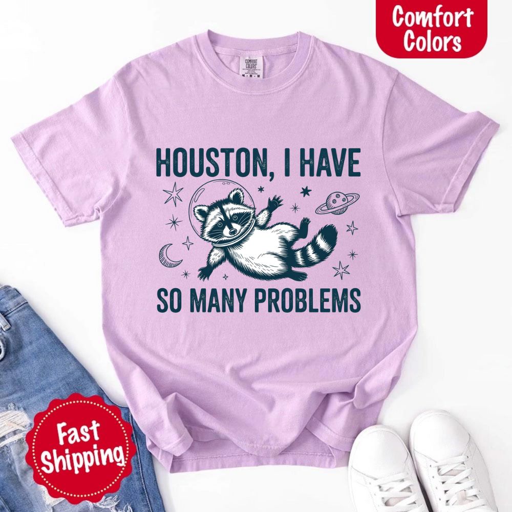 Houston I Have So Many Problems Raccoon Comfort Colors T-Shirts in lavender with funny space raccoon design, fast shipping available.