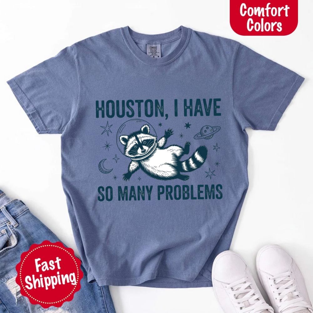 Houston I Have So Many Problems Raccoon Comfort Colors T-Shirts featuring a raccoon in space, ideal for humor and comfort.